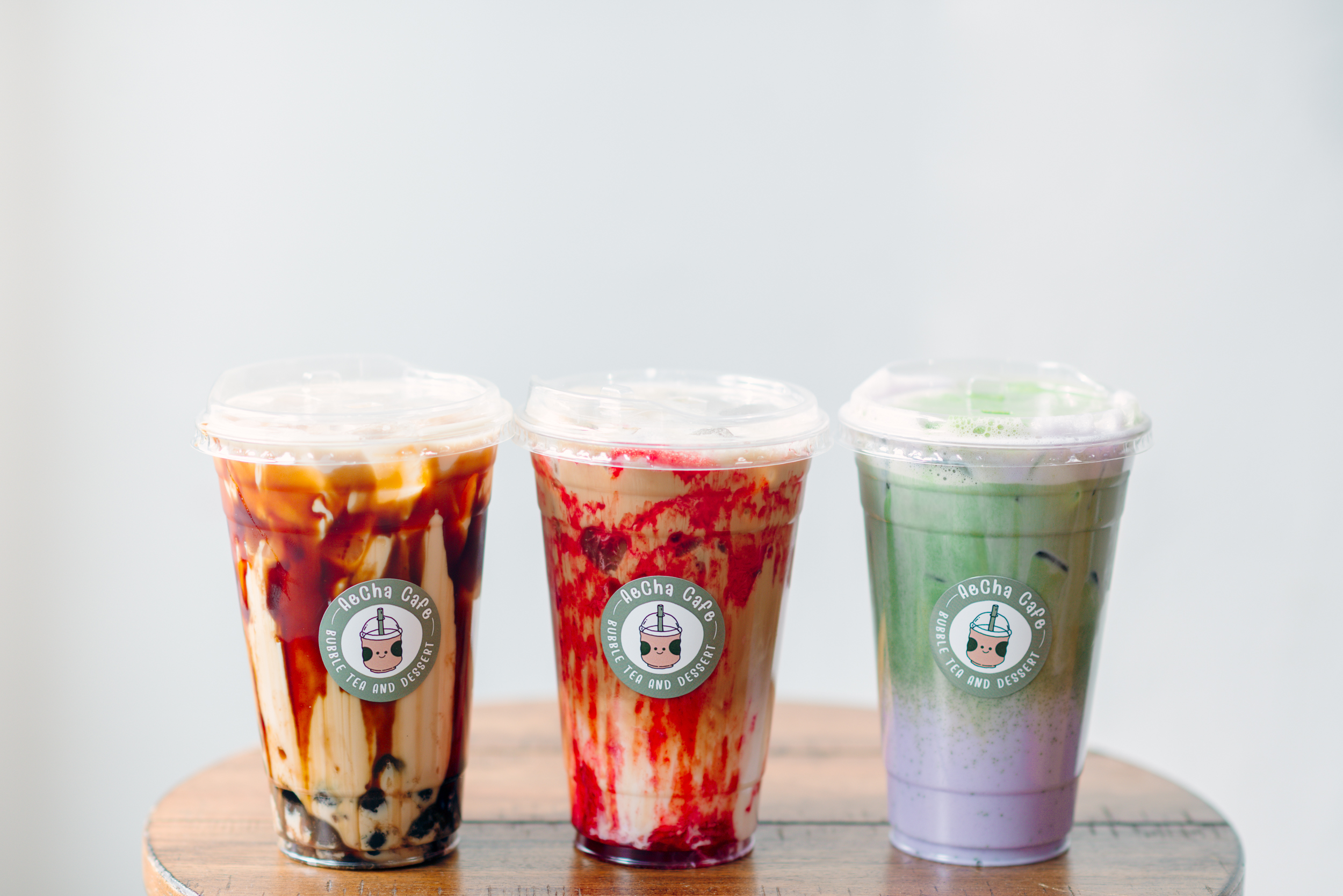 AeCha Cafe in Tipp City Serves Boba Tea, Coffee, and Desserts. This picture has Tiger Milk Tea with Tapioca, Strawberry Espresso, and Taro Matcha Latte.